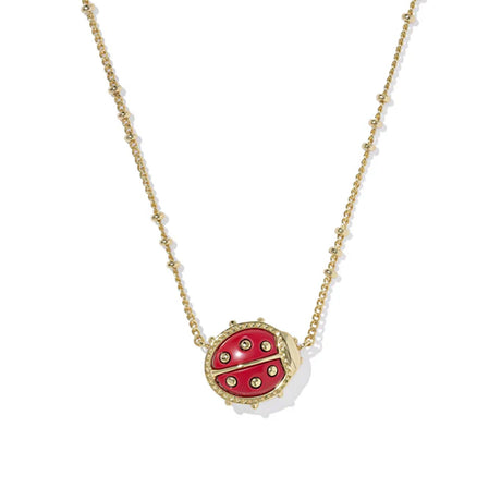 Red ladybug pendant necklace on a gold chain against a white background