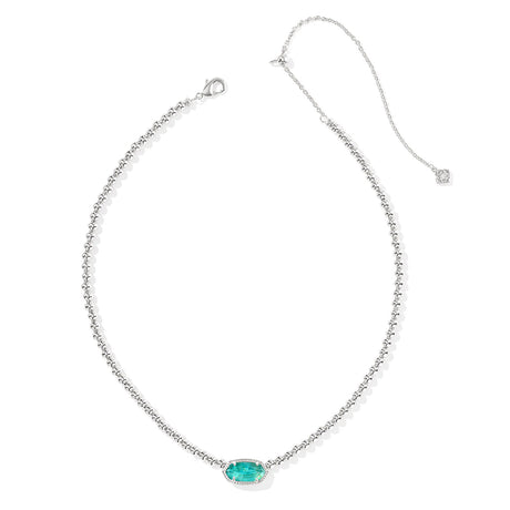 Silver necklace with a green gemstone pendant on a white background