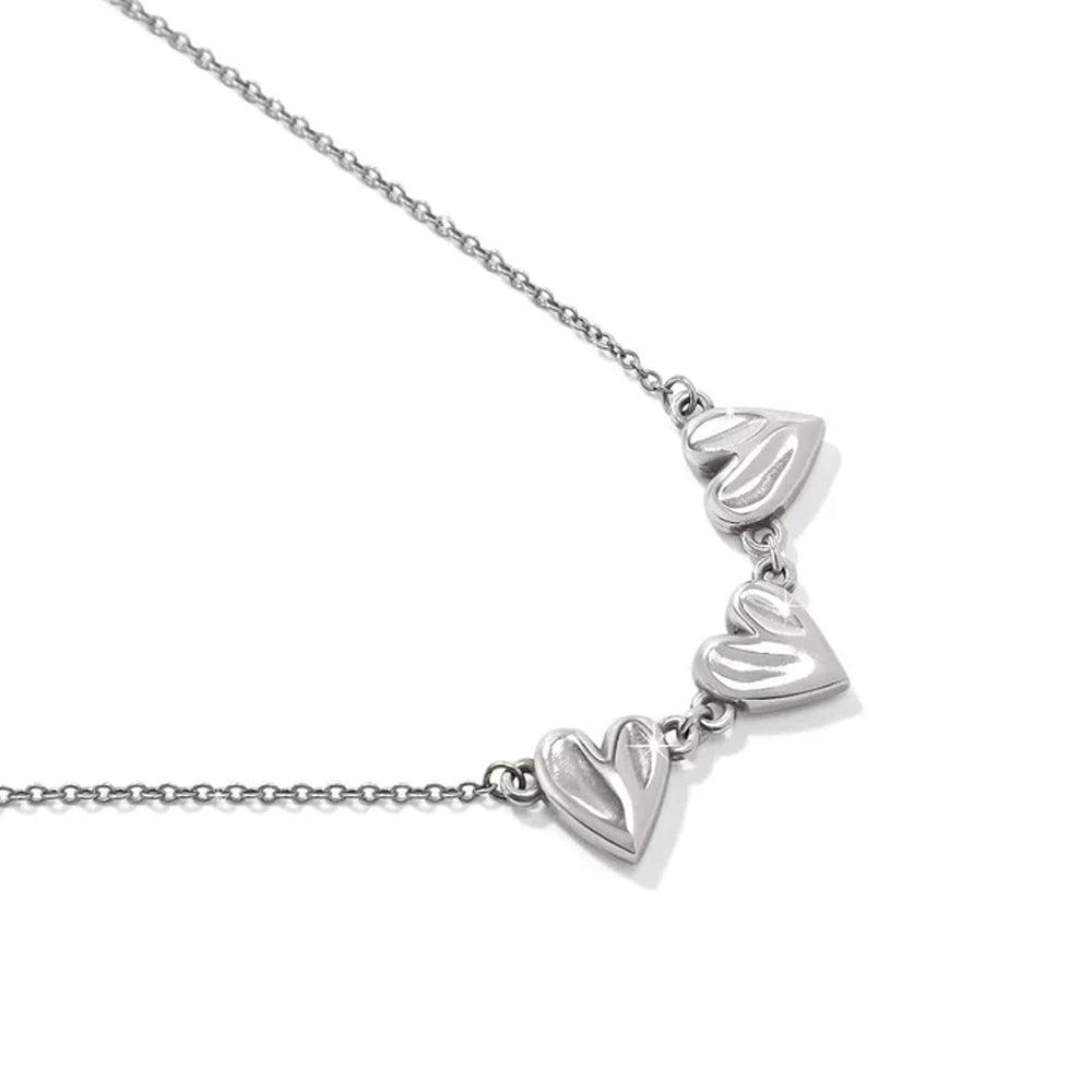 Silver necklace with heart-shaped pendants on a white background