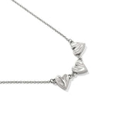 Silver necklace with heart-shaped pendants on a white background