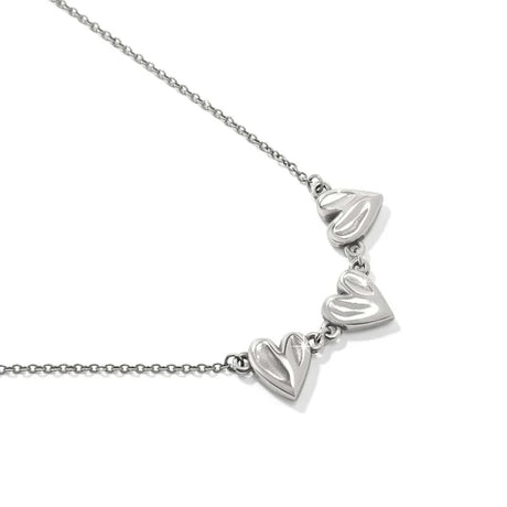 Silver necklace with heart-shaped pendants on a white background