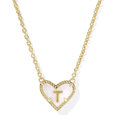 Gold necklace with a heart-shaped pendant featuring the letter 'T' on a white background