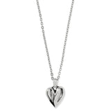 Silver heart-shaped pendant on a chain against a white background