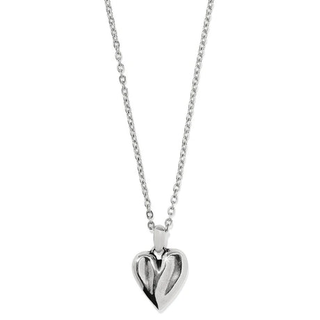 Silver heart-shaped pendant on a chain against a white background