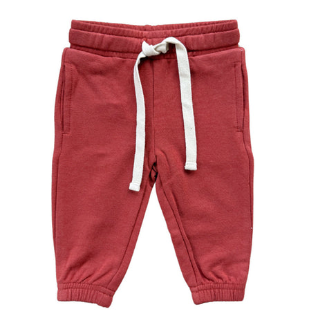 Red sweatpants with a white drawstring on a white background