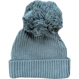 Blue knit beanie with a textured pom-pom on a white background