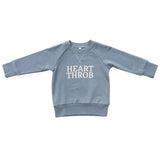 Blue sweatshirt with 'HEART THROB' text on a white background