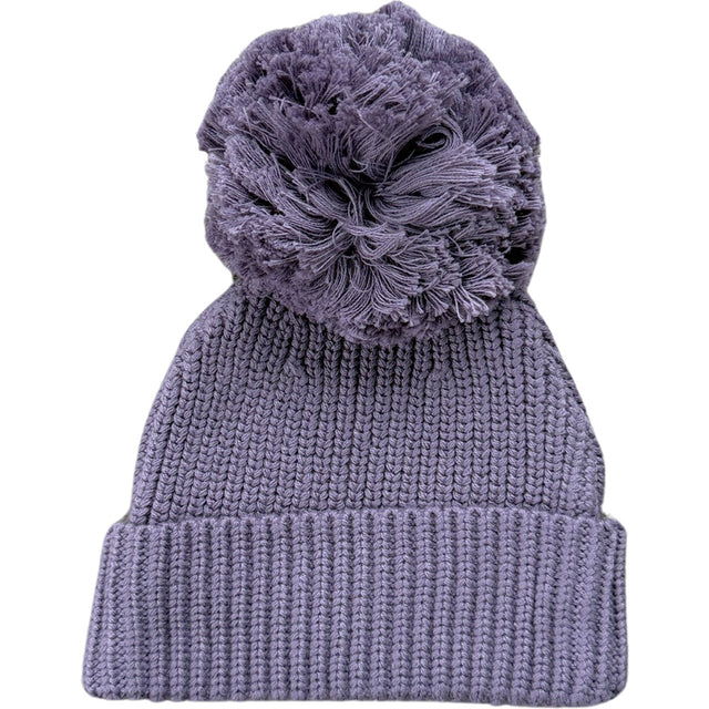 Knitted beanie with a large pom-pom on a white background