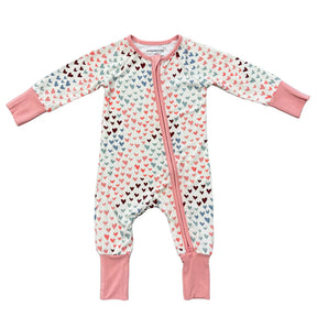 Baby onesie with heart pattern and pink accents on a white background