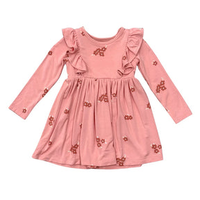 A pink long-sleeve dress for toddlers or girls, featuring ruffled shoulder details, a gathered waist, and small brown floral prints scattered across the fabric, shown against a plain white background.