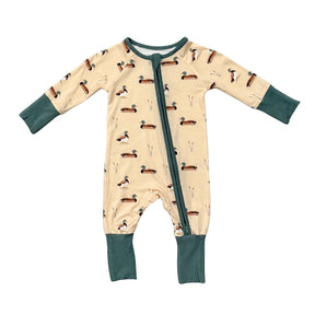 Baby onesie with duck pattern on a beige background
