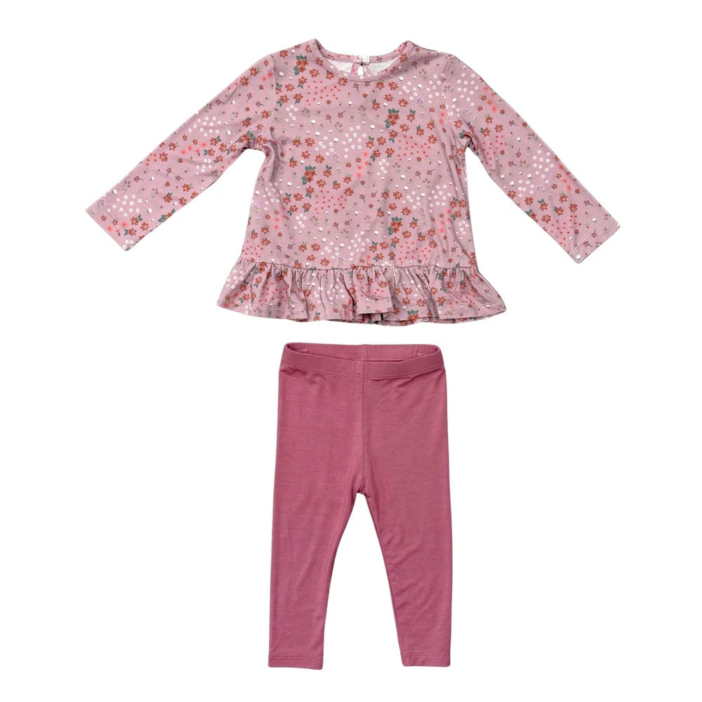 A toddler girl's two-piece clothing set featuring a long-sleeve top with a pink floral pattern and ruffle hem, paired with matching solid dusty rose leggings, shown on a plain white background.