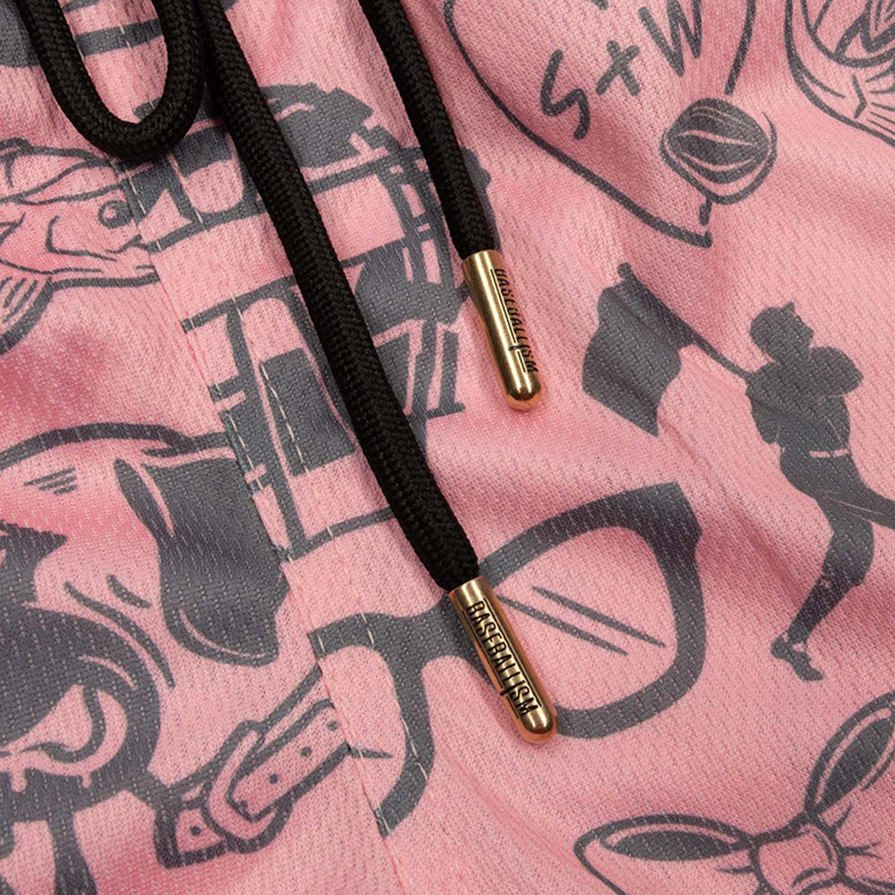 Close-up of a pink graphic with black drawstrings and gold metal tips, featuring black line art illustrations including glasses, a fish, and a person holding a flag.