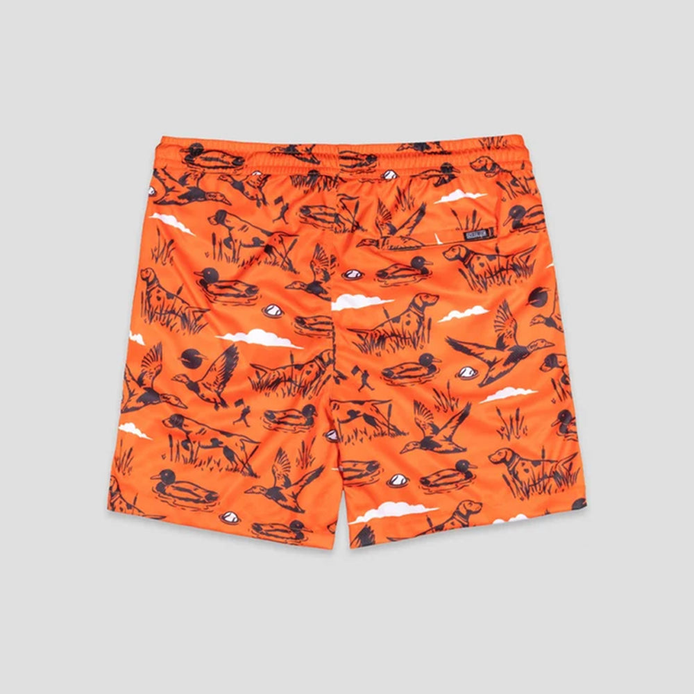 Bright orange shorts with an allover black duck hunting pattern, including ducks, rifles, marsh grass, and clouds, shown flat on a light gray background.