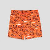 Bright orange shorts with an allover black duck hunting pattern, including ducks, rifles, marsh grass, and clouds, shown flat on a light gray background.