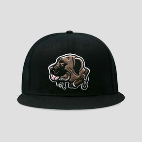A black flat-brim snapback cap featuring a detailed embroidered patch of a brown dog with dripping white and red accents on the front, set against a solid light gray background.