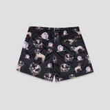 Black athletic shorts featuring an all-over print of pug dogs and baseballs, with a small brown brand patch on the right waistband, shown against a light gray background.