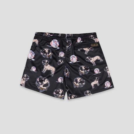 Black athletic shorts featuring an all-over print of pug dogs and baseballs, with a small brown brand patch on the right waistband, shown against a light gray background.
