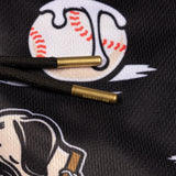 Close-up of black drawstring cords with gold-toned metal tips on a black hoodie featuring a baseball graphic.