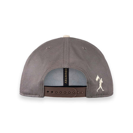 The back view of a Country American Apparel baseball cap in a muted gray color, featuring a brown adjustable strap and a small white embroidered logo on the side.