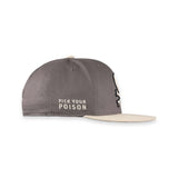 A dark gray snapback cap with a beige flat brim, featuring the embroidered text 'PICK YOUR POISON' on the front and a black-and-white skull graphic on the side.