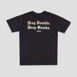 A black short-sleeve t-shirt with the text 'Stay Humble. Drop Bombs.