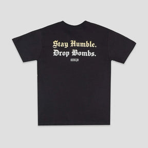 A black short-sleeve t-shirt with the text 'Stay Humble. Drop Bombs.