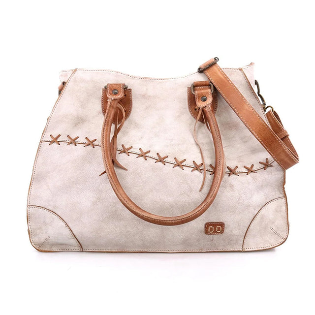 Beige handbag with brown leather straps and stitching on a white background