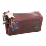 A distressed reddish-brown leather shoulder bag with a star-shaped leather charm featuring a white star on the top and a blue star on the bottom, attached with brown leather cords and metal rings.