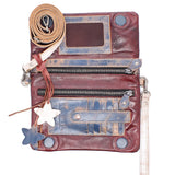 A distressed leather crossbody bag in reddish-brown with blue-toned weathered patches, multiple zip compartments, a rolled tan strap, and star-shaped charms on a plain white background.