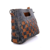 Woven leather handbag with blue and brown pattern on a white background