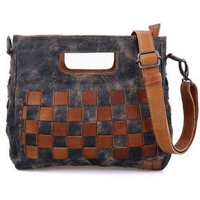 Handbag with woven pattern and brown strap on a white background