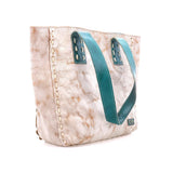 A large tote bag with a distressed beige and white marbled pattern, featuring prominent teal blue handles and decorative gold-toned stitching along the side.