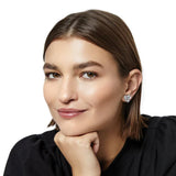 Woman wearing a heart-shaped earring on a white background