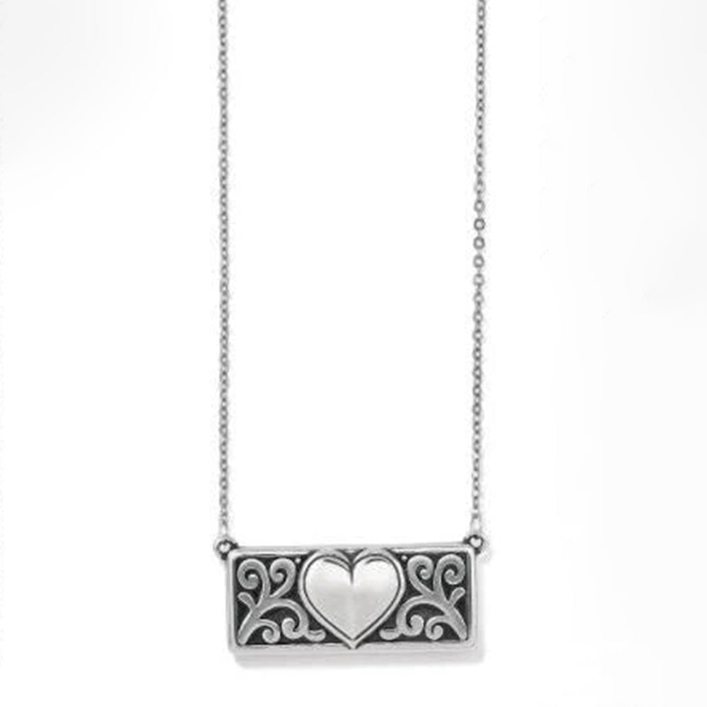 Silver necklace with a heart-shaped pendant on a white background