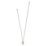 A delicate silver chain necklace featuring a double-circle pendant with a small gold bead at the bottom, displayed on a solid white background.