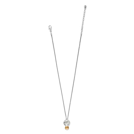 A delicate silver chain necklace featuring a double-circle pendant with a small gold bead at the bottom, displayed on a solid white background.