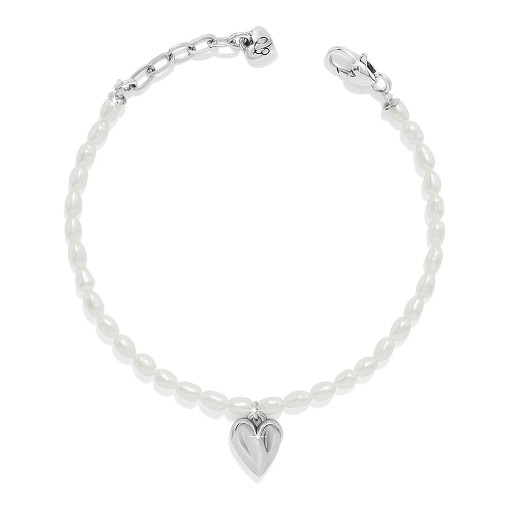Silver bracelet with a heart charm on a white background