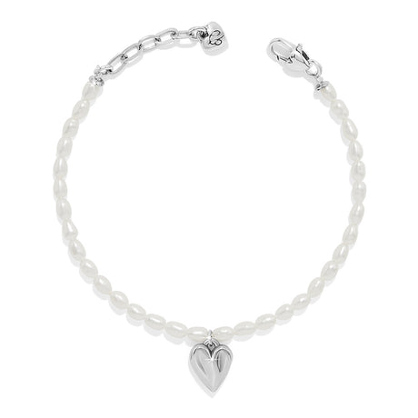 Silver bracelet with a heart charm on a white background