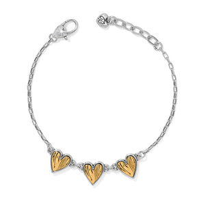 Bracelet with gold heart-shaped charms on a white background