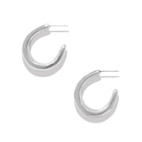 A pair of polished silver crescent hoop earrings with post backs, displayed on a clean white background with soft drop shadows.
