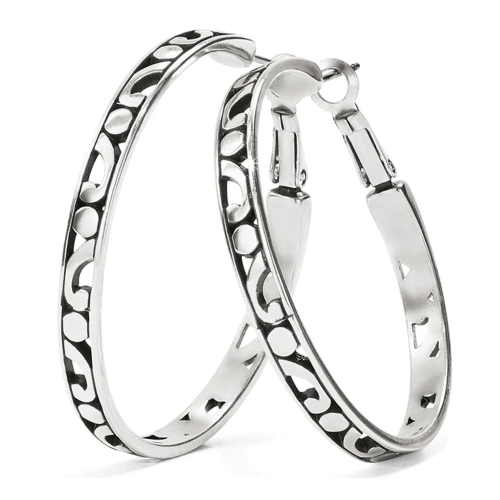 Pair of silver hoop earrings with intricate patterns on a white background