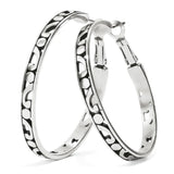 Pair of silver hoop earrings with intricate patterns on a white background