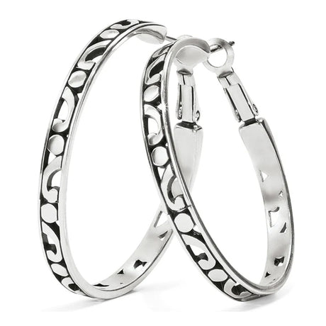 Pair of silver hoop earrings with intricate patterns on a white background