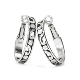 Pair of silver hoop earrings with intricate designs on a white background