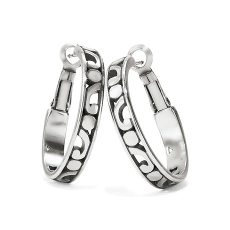 Pair of silver hoop earrings with intricate designs on a white background
