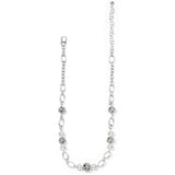 Silver chain necklace with white beads on a white background