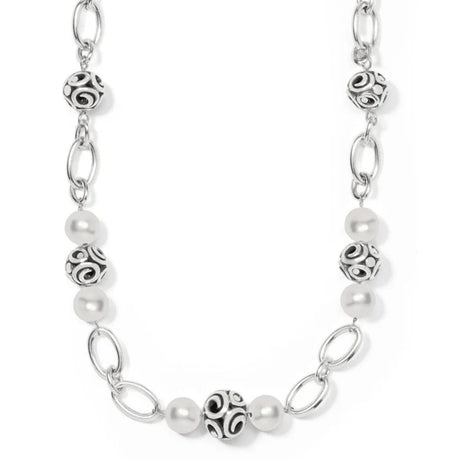 Silver chain necklace with pearl beads on a white background