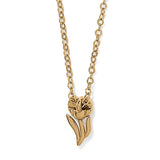 Gold necklace with a tulip-shaped pendant on a white background