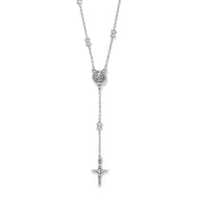 A silver rosary-style necklace featuring a central oxidized circular medallion, small star accents along the chain, and a dangling crucifix pendant at the bottom, shown on a plain white background.